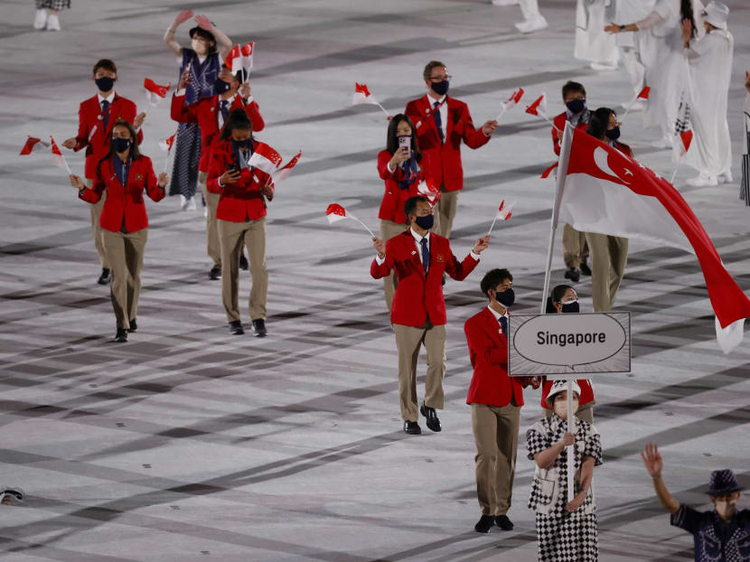 Flagbearers Yu Mengyu and Kean Yew Loh lead the Team Singapore contingent in the athletes parade during the Tokyo Olympics opening ceremony on July 23, 2021.