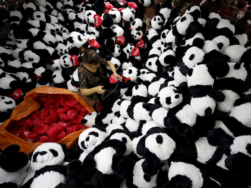 Photo of the day: A worker processes panda soft toys for export to American and European markets at a factory in Lianyungang, Jiangsu province. Photo: Reuters
