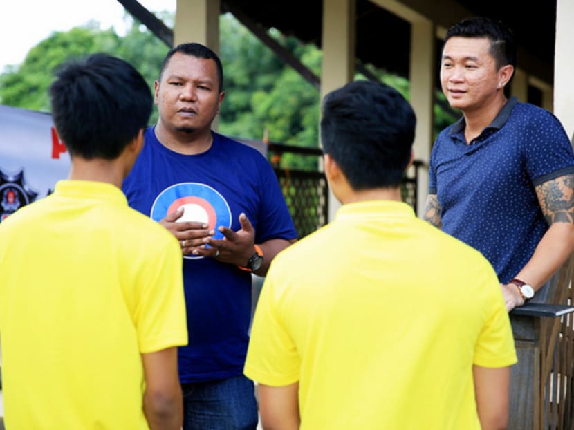 Former gang members Azmi Abdul Rehman (left), 43, and Kim Whye Kee, 37, sharing their real-life experiences with the youths who participated in the residential camp for 

at-risk youths. Photo: Koh Mui Fong