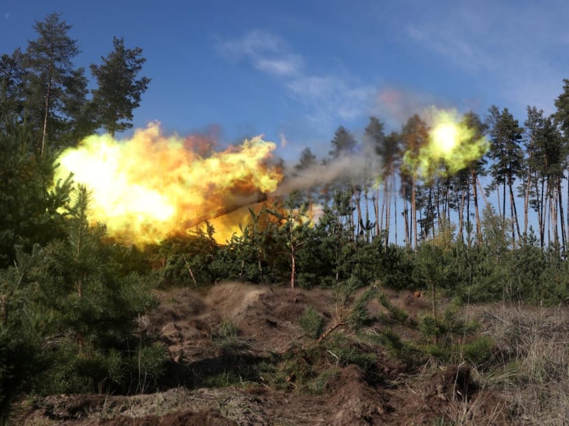 Ukrainian artillerymen fire from a gun from their position in Kharkiv region on Oct 17, 2022, amid the Russian military invasion of Ukraine.