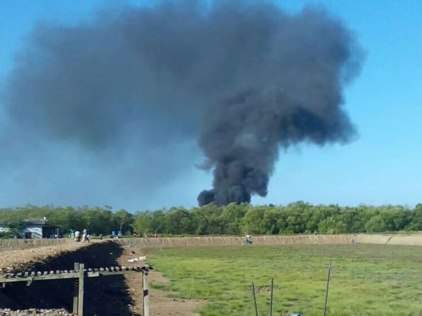Thick black smoke could be seen from the crash site on Feb 26, 2016. Photo: The Malaysian Insider