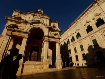 FILE PHOTO: People walk outside the Church of St Catherine of Italy in Valletta, Malta, July 13, 2022. REUTERS/Darrin Zammit Lupi/File Photo