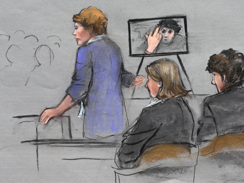 In this courtroom sketch, prosecutor Ms Nadine Pellegrini displayed a photo to the jury of Tsarnaev extending his middle finger to a security camera taken in his jail cell three months after the attack. Photo: AP