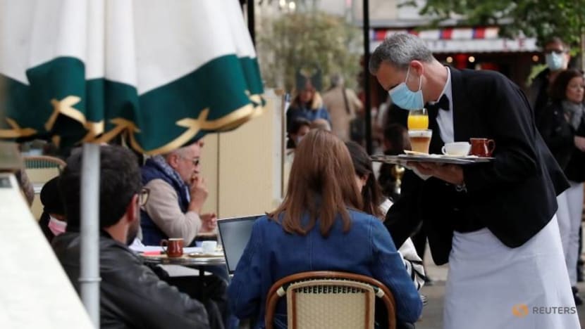 Parisians tuck into coffee and croissants again as cafes re-open Parisians tuck into coffee and croissants again as cafes re-open