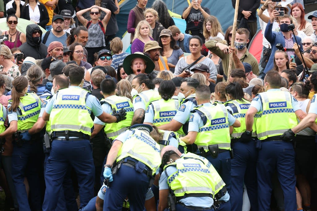 Protesters resist police after refusing to leave parliament grounds during the third day of demonstrations against Covid restrictions in Wellington on Feb 10, 2022.