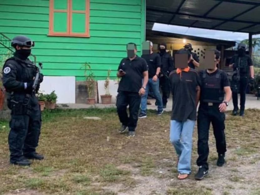 Malaysian security officers taking away a suspected militant in Sabah in May 2019.
