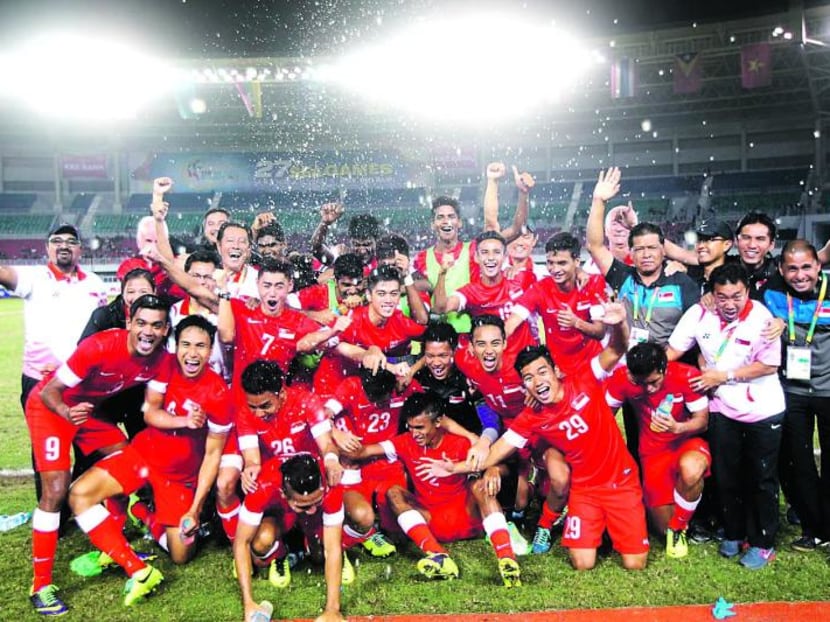 Singapore's Under-23 team celebrating winning the bronze medal at the 2013 SEA Games in Myanmar. Pundits said Singapore should set a goal of winning its first SEA Games football title first.