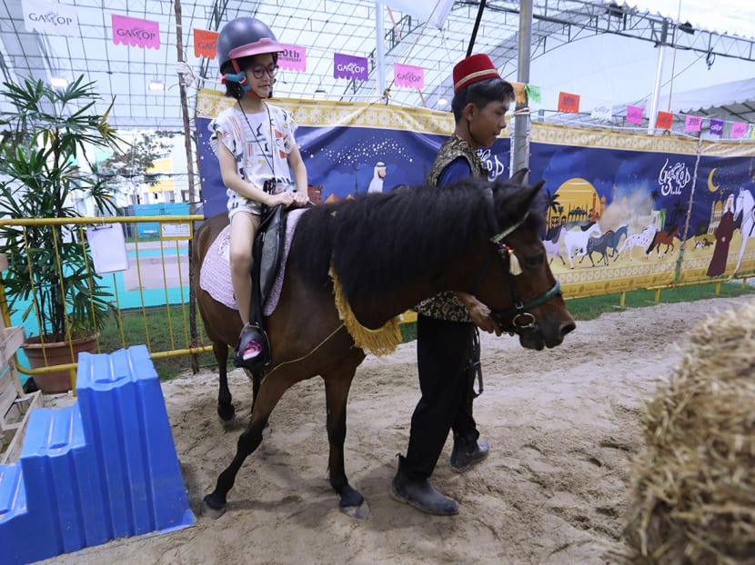 A child riding a pony at the Geylang Serai Ramadan bazaar on March 26, 2023. 