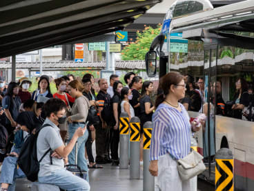 Commuters at a bus stop next to the Woodlands Checkpoint on Feb 28, 2024. The Malaysian government recently released an official study into Malaysians living in Singapore, and warned of the "adverse effects" of the brain drain as skilled workers leave Malaysia.