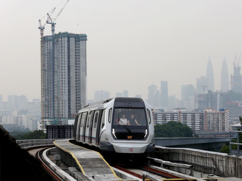 An MRT train coming towards Taman Midah station, against the backdrop of the Kuala Lumpur city skyline, shot on July 25, 2017. Photo: Nuria Ling/TODAY