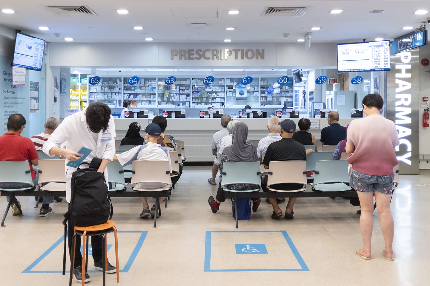 People waiting at a polyclinic to collect medication. People waiting at a polyclinic to collect medication.