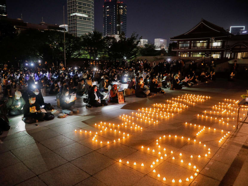 Participants including Myanmar residents in Japan and monks hold a candlelight vigil to protest against Myanmar's military coup and mourn protesters killed in the crackdown at Zojoji temple in Tokyo, Japan on April 18, 2021.