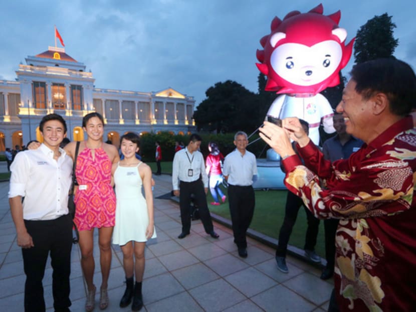 Deputy Prime Minister Teo Chee Hean takes a photo of siblings Quah Zheng Wen, Quah Ting Wen and Quah Jing Wen at an Istana Garden Party held to celebrate Team Singapore's outstanding performance at the recent 28th SEA Games on 13 Jul 2015. Photo: Ooi Boon Keong/TODAY