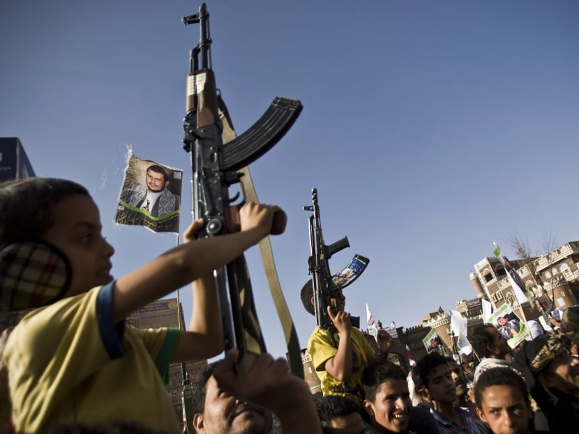 Boys hold weapons as Shiite rebels known as Houthis gather to protest against Saudi-led airstrikes, during a rally in Sanaa, Yemen. Photo: AP