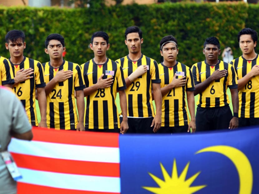 Malaysian footballers before their match against Thailand yesterday. Midfielder Nazmi Faiz was red-carded for a spitting incident last Saturday against Timor Leste and sent home after being served a six-match suspension. Photo: Singapore SEA Games Organising Committee / Action Images via Reuters