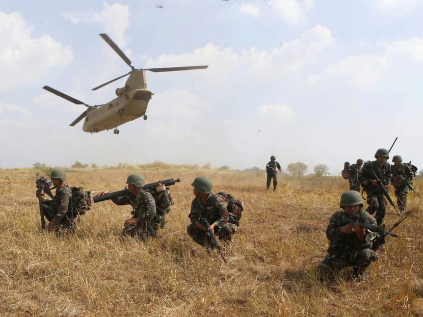Filipino soldiers taking their positions as a US military helicopter lifts off during the annual Balikatan (shoulder-to-shoulder) war games at a military camp, in northern Philippines on April 20 last year. Many Filipino military officers were trained in the US, and the two nations have staged joint military exercises for decades. Photo: REUTERS