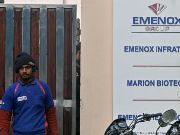 A man walks past the office entrance of Marion Biotech, a pharmaceutical company in Noida on the outskirts of New Delhi on Dec 29, 2022. 