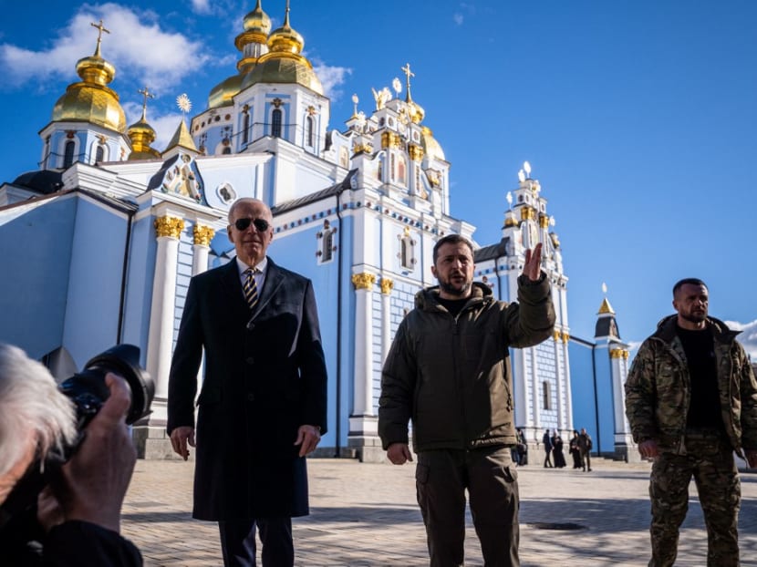 US President Joe Biden (L) walks next to Ukrainian President Volodymyr Zelensky (2nr R) in front of St. Michael’s Golden-Domed Cathedral as he arrives for a visit in Kyiv on Feb 20, 2023.