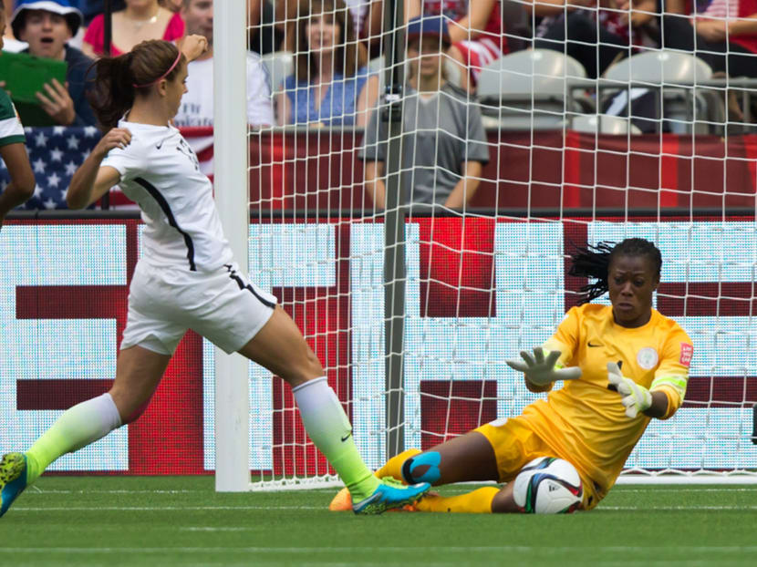 Nigeria goal keeper Precious Dede, right, stops United States' Alex Morgan  during the first half of a FIFA Women's World Cup soccer match, Tuesday, June 16, 2015 in Vancouver, New Brunswick. Photo: AP