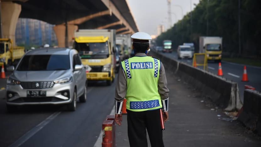 'It's a cat and mouse game', says Jakarta traffic cop at the frontline of enforcing Idul Fitri travel ban