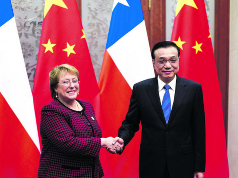 Chinese Premier Li Keqiang (right) meeting Chilean President Michelle Bachelet in Beijing last year. China is keen to gain access to raw materials and investment returns, while Latin American countries are keen for an influx of Chinese cash.  Photo: Reuters