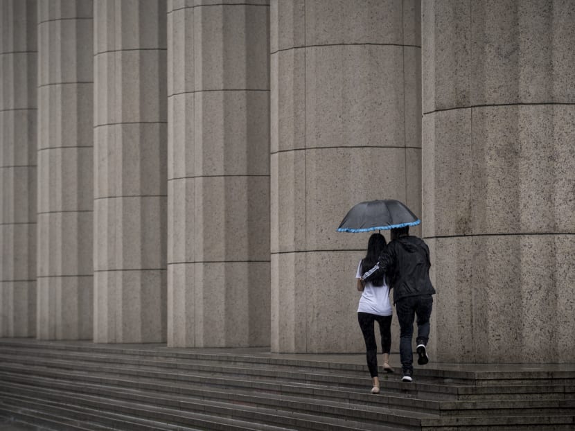 A couple walking through the rain in Shanghai. Photo: AFP