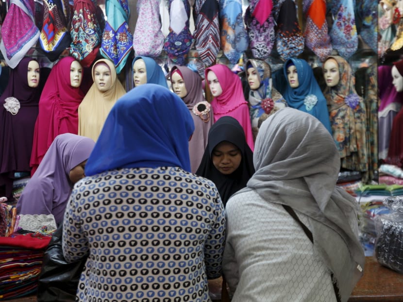 Women shopping for hijab at a traditional retail market in Jakarta. Almost 80 per cent of Muslim women surveyed wear the Islamic headscarf, with the figure rising together with education and income. Photo: Reuters