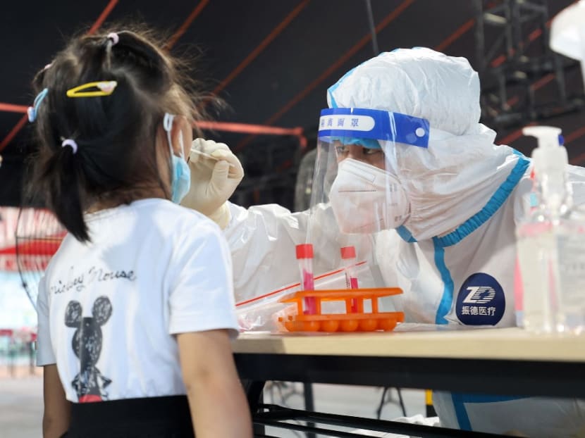This photo taken on Aug 10, 2022 shows a health worker conducting a swab test on a child for the Covid-19 coronavirus in Xiamen, in China's eastern Fujian province.

