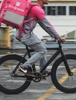 A Foodpanda delivery rider makes his rounds on a bicycle. 