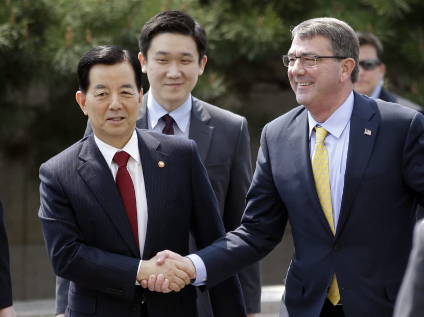 In this Friday, April 10, 2015 photo, US Defence Secretary Ash Carter, right, shakes hands with his South Korean counterpart Han Min Koo upon his arrival at the Defence Ministry in Seoul, South Korea. Photo: AP