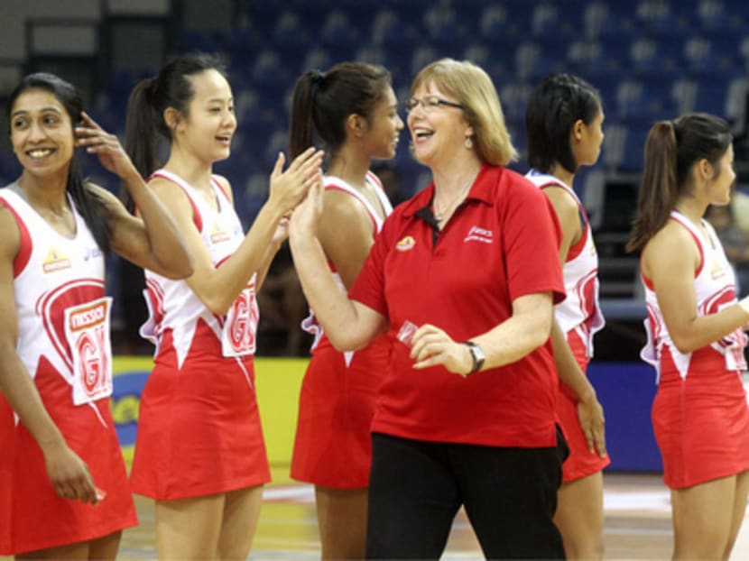 Coach Ruth Aitken (right) with the Singapore players at the start of a match at the Netball Nations Cup last month. She is expected to name her 12 players in March. Photo: Ooi Boon Keong
