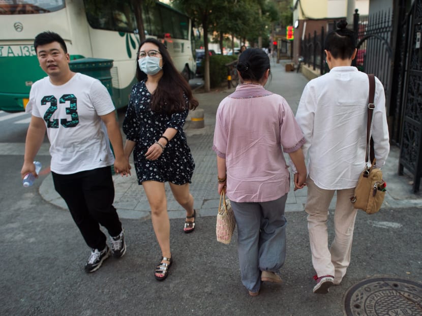 In this picture taken on July 3, 2017 Xiaoxiong (R) and Xiaojing (2nd R) walk in a street in Sheynyang. Photo: AFP
