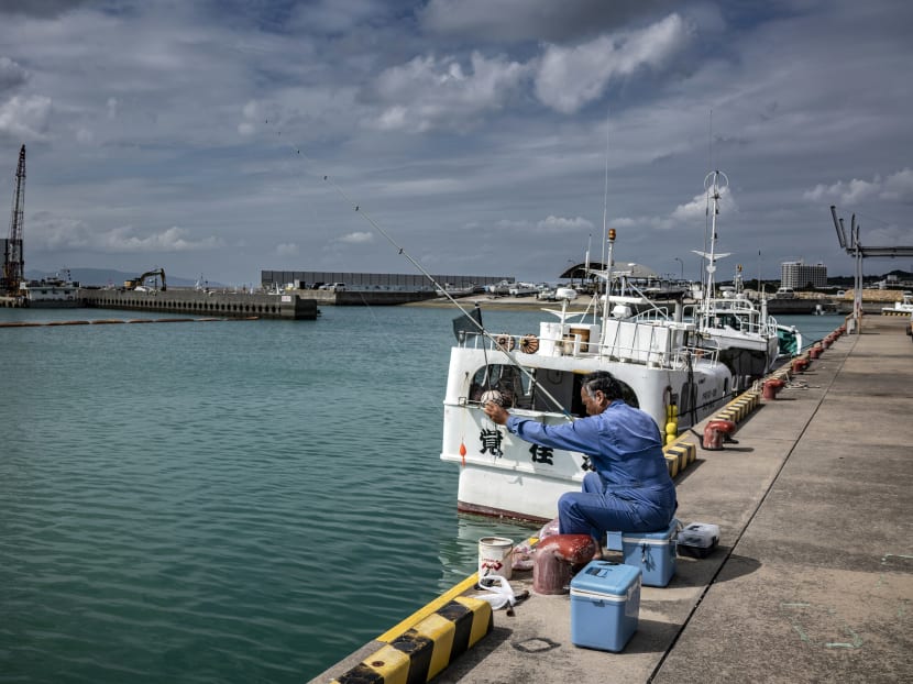 A man fishes from a pier on Ishigaki, a small Japanese island just 200 miles (322km) from Taiwan, on Nov 4, 2021. Japan has warned that growing tensions between Chinese and American forces could pose a serious risk to regional stability. 
