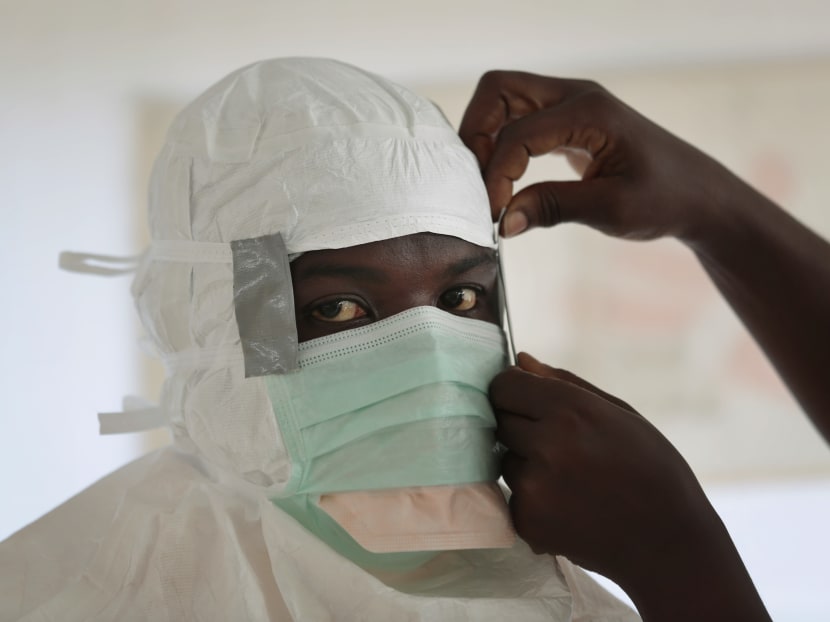 In this Sept 29, 2014, file photo a Medecins Sans Frontieres nurse gets prepared with Personal Protection Equipment before entering a high risk zone of MSF's Ebola isolation and treatment center in Monrovia, Liberia. Photo: AP