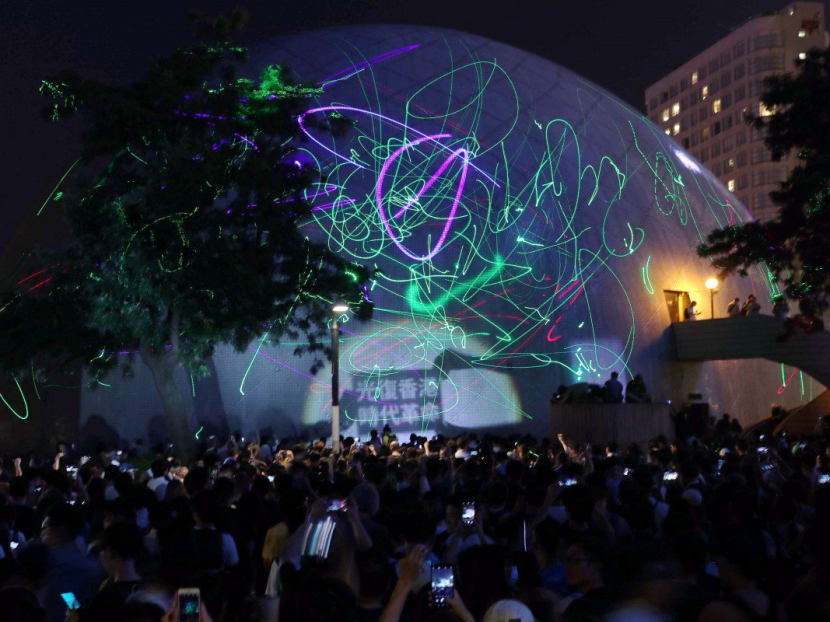 Protesters light up the Hong Kong Space Museum in Tsim Sha Tsui in protest after police arrested a student for possession of laser pointers, which authorities claim is an offensive weapon.