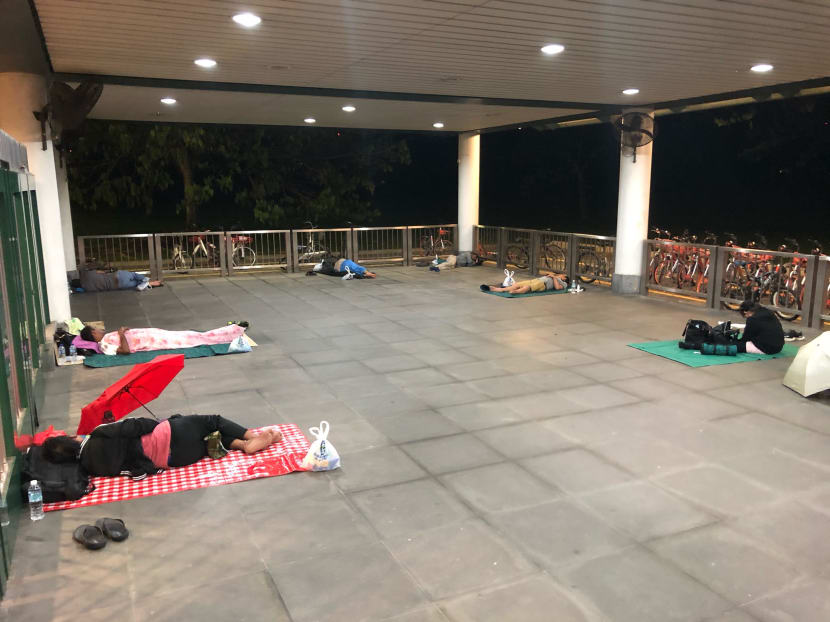 At least 20 Malaysian workers were seen sleeping behind the gates of Kranji MRT Station on March 18, 2020.