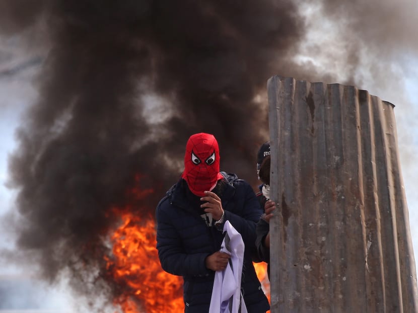Photo of the day: A masked Kashmiri protester standing in front of a burning tyre during a protest near the site of a gun battle between Indian security forces and suspected militants in Srinagar on Wednesday (Oct 17).