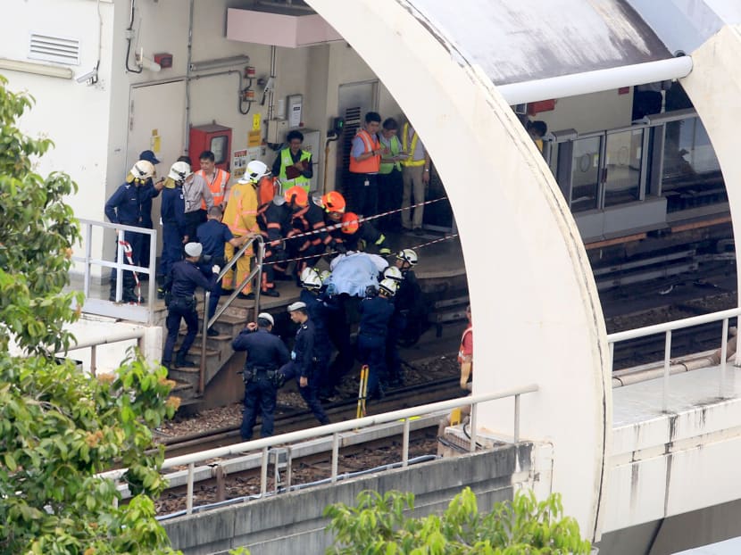 SCDF officers bringing one of the bodies to the platform at 
Pasir Ris MRT Station on March 22, 2016. Photo: Koh Mui Fong