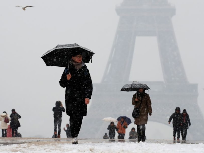 Photo of the day: People use umbrellas against the snow as they walk on the Trocadero esplanade across from the Eiffel Tower in Paris, as winter weather hits France on Tuesday, January 22, 2019.