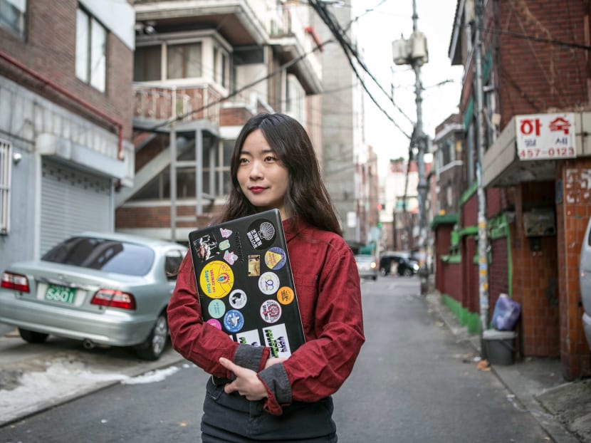 Lee Na-yeon, a philosophy major who had an abortion five years ago, holds a laptop case showing her support for women’s causes in Seoul, South Korea, Dec. 14, 2017. Lee wants South Korea’s ban on the procedure lifted so that other women won’t go through the anguish she did. Photo: The New York Times
