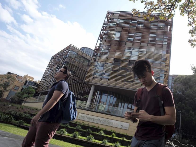 University students walk outside the School of Business Building at the University of Sydney in Australia.