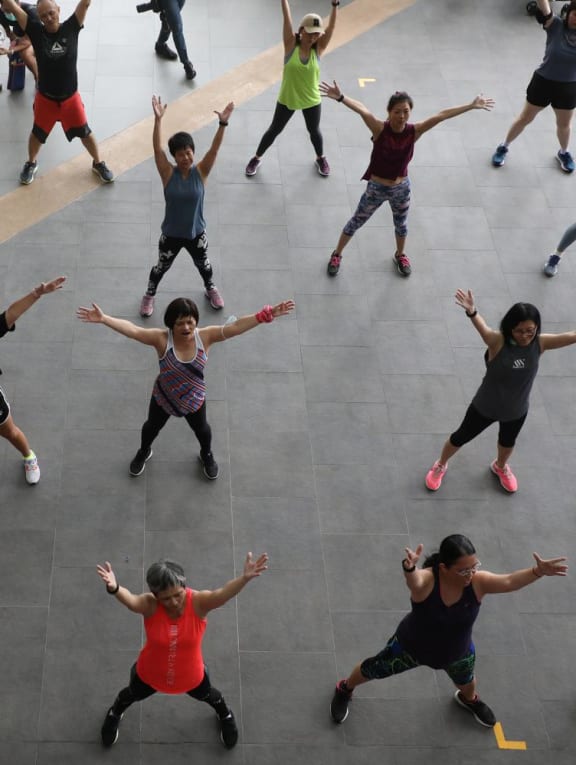 Participants joining in a Zumba workout, an aerobic activity, at the launch of the Singapore Physical Activity Guidelines at Canberra Plaza on June 12, 2022.