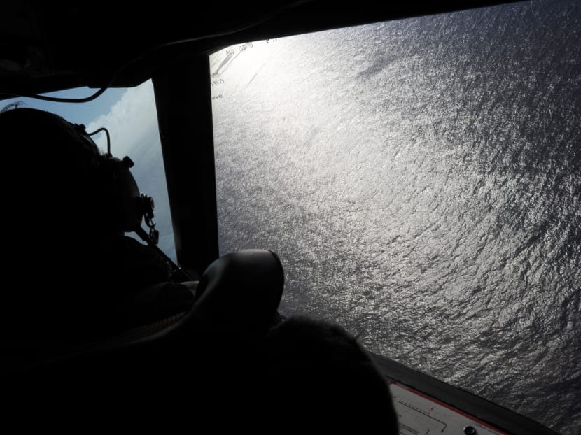 In this April 13, 2014 file photo, taken from the Royal New Zealand Air Force P-3K2-Orion aircraft, co-pilot Squadron Leader Brett McKenzie looks out of a window while searching for debris from missing Malaysia Airlines Flight 370, over the Indian Ocean off the coast of western Australia. The yearlong search for Malaysia Airlines Flight 370 has turned up no sign of the plane, but that doesn’t mean it’s been unproductive. Photo: AP