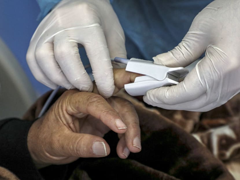 A Covid-19 patient's blood oxygen saturation level being measured with a pulse oximeter in an overseas facility. A Covid-19 patient's blood oxygen saturation level being measured with a pulse oximeter in an overseas facility.