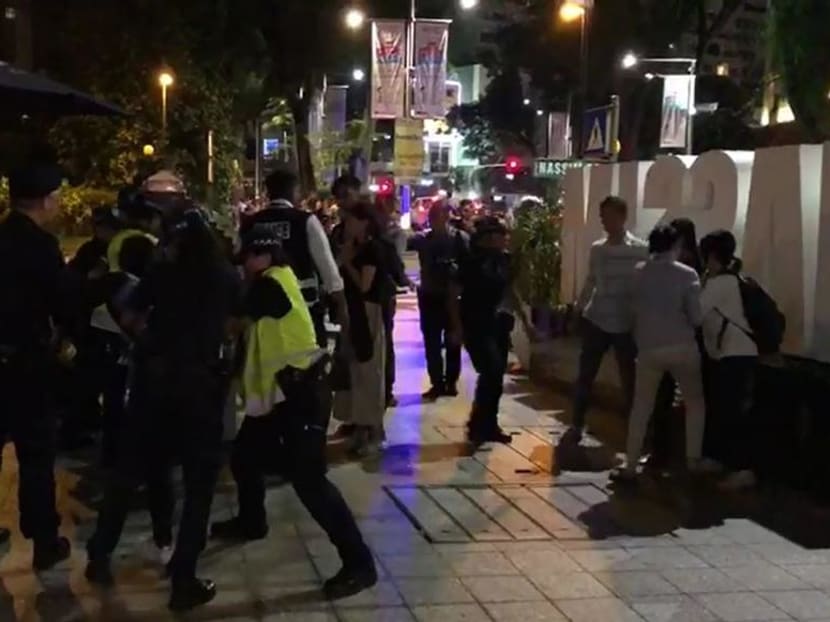 Police detain South Korean protesters across St Regis on June 11, 2018 in this still image taken from video. They have since been repatriated back to their home country.