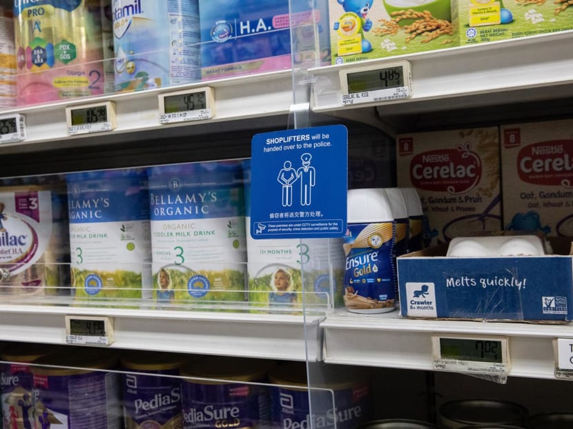 Shelves of baby milk powder locked behind screens at an NTUC FairPrice supermarket in Bukit Batok on Jan 18, 2023.