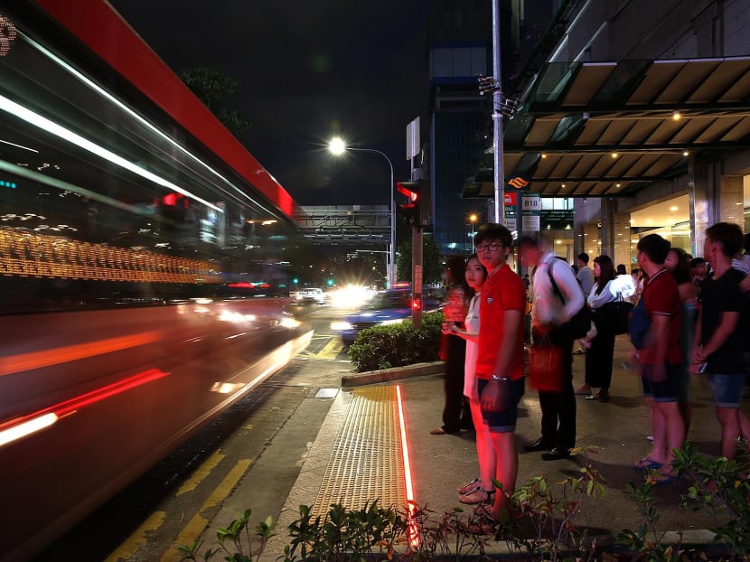 Pedestrians wait behind a new LED strip installed by the Land Transport Authority at a crossing along Victoria Street, May 9, 2017. Photo: Wee Teck Hian/TODAY