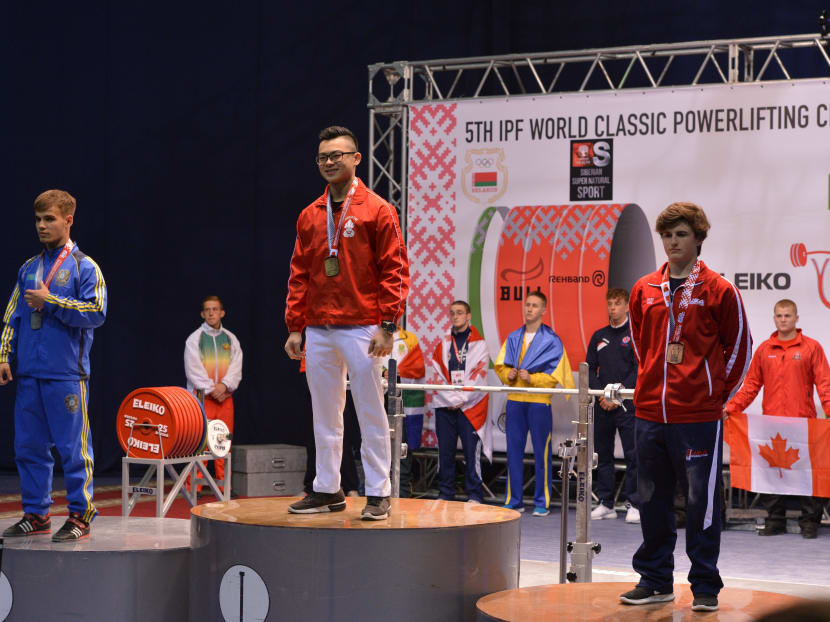Matthew Yap standing on the podium after his world-record effort. Photo: International Powerlifting Federation