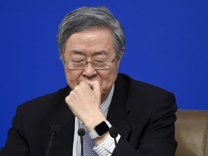 Governor of the People's Bank of China Zhou Xiaochuan listens at a press conference during the Fifth Session of the 12th National People's Congress (NPC) in Beijing. Photo: AFP