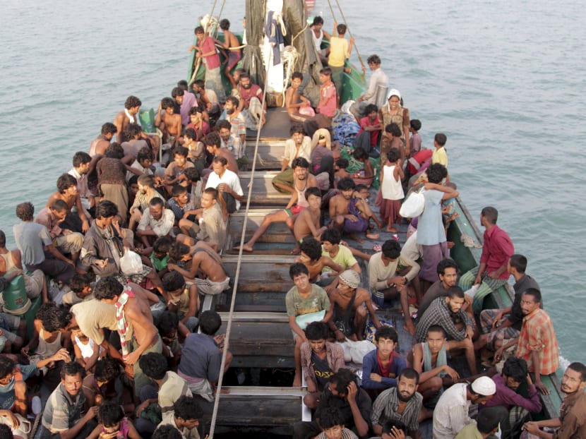 Rohingya and Bangleshi migrants wait on board a fishing boat before being transported to shore, off the coast of Julok, in Aceh province, May 20, 2015 in this photo taken by Antara Foto via Reuters.